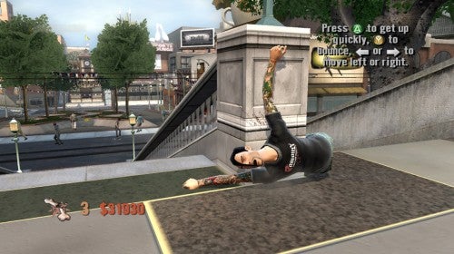A screenshot from the video game Tony Hawk's Project 8 on Xbox 360 showing an in-game character, who has taken a fall while skateboarding, lying on the ground with point deduction visible and on-screen instructions prompting the player to press buttons to quickly get up.