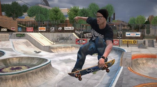 A screenshot from Tony Hawk's Project 8 video game for Xbox 360, depicting a character performing a skateboarding trick in a virtual skate park environment with various ramps and railings, and branded billboards in the background.