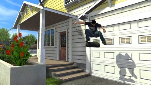 A screenshot from Tony Hawk’s Project 8 video game showing a character performing a skateboard trick off the stairs in front of a suburban house.