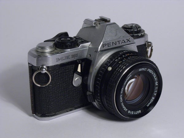 Vintage Pentax ME Super 35mm film camera with SMC Pentax-M lens displayed on a neutral background.