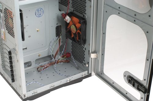 Interior view of an open Thermaltake Mozart TX computer case showing empty drive bays and wire harnesses, with a side panel removed.