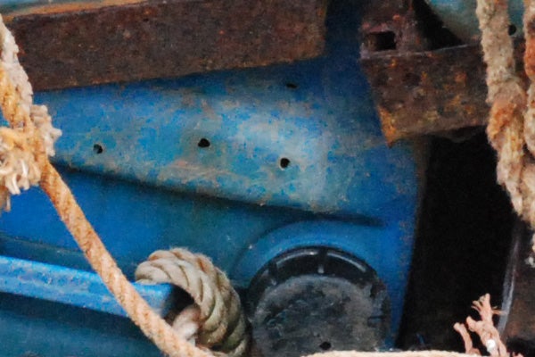 Close-up of weathered blue machinery with rust and rope, possibly taken to demonstrate the high-resolution detail captured by the Nikon D80 10MP Digital SLR camera.