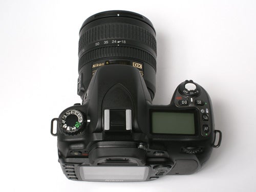 Nikon D80 10MP Digital SLR camera with a Nikon DX zoom lens mounted, viewed from above showing the top control dials, shutter release button, and display screen.