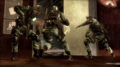 Three characters in tactical gear from the video game Tom Clancy's Rainbow Six: Vegas for Xbox 360 are advancing through a casino environment with guns drawn and ready for combat.
