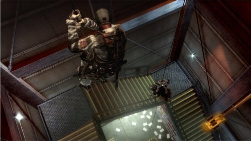 Screenshot from Tom Clancy's Rainbow Six: Vegas for Xbox 360 showing two characters rappelling down an elevator shaft with a third character watching from below.