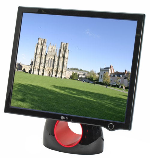 LG L1900R monitor with a distinctive red circular stand displaying a vibrant image of a cathedral and surrounding greenery.