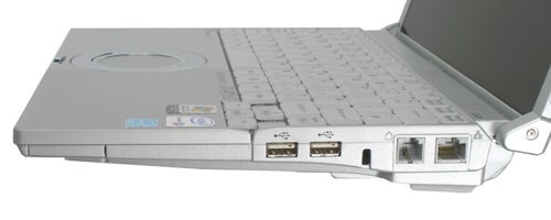 A Panasonic ToughBook CF-W5 laptop with a silver finish, partially opened, showing the keyboard and the side ports including USB and Ethernet ports.