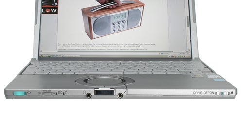 Panasonic ToughBook CF-W5 laptop with a metallic finish open on a flat surface displaying its screen and keyboard, and an image of a radio on its screen.