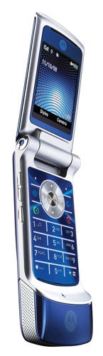 Motorola MOTOKRZR K1 flip phone with blue illuminated keypad open, displaying the home screen with time and menu icons.