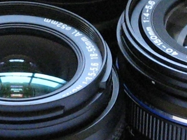 Close-up of a Canon camera lens with focal length markings visible.
