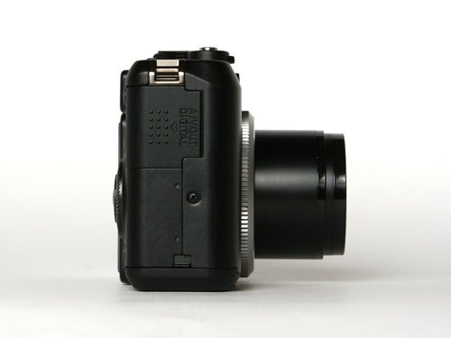Side view of a Canon PowerShot G7 camera showing the lens barrel, control buttons, and connectivity ports.
