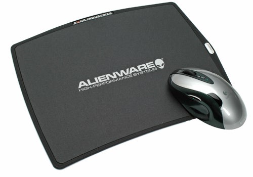 Alienware-branded mousepad with the company logo and a wireless mouse on top, indicative of the brand's gaming accessories range.