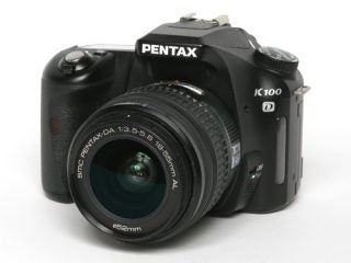 Pentax K100D Digital SLR camera with a standard zoom lens on a white background.