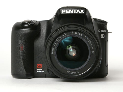 Pentax K100D Digital SLR camera with a mounted SMC Pentax-DA 18-55mm lens on a white background.
