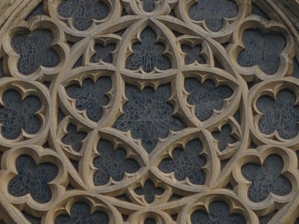 Detailed stone gothic window tracery showing intricate design patterns and geometry.