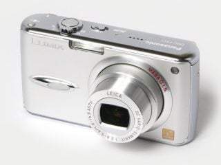 A Panasonic Lumix DMC-FX01 digital camera in silver with the lens retracted and Leica branding visible on the front.