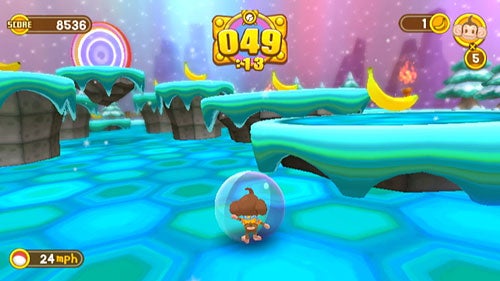 A screenshot of gameplay from Super Monkey Ball: Banana Blitz showing a character inside a transparent ball navigating through an ice-themed level with platforms and a score display at the top.