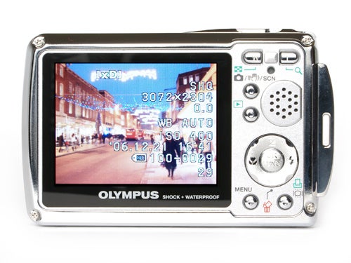 Olympus mju 725 SW digital camera with a street scene displayed on its LCD screen, showing camera settings and functions on the display.