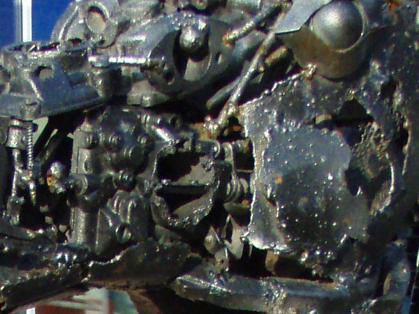 Close-up of a damaged and corroded Olympus mju 725 SW camera, showing signs of extreme use or exposure to harsh conditions.