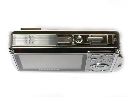 An Olympus mju 725 SW digital camera shown from the back, displaying its LCD screen and control buttons, with a metallic finish and branding visible.