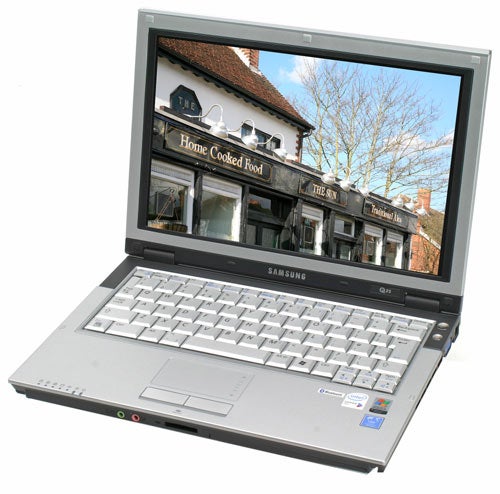 Samsung Q35 Red Core 2 Duo laptop open and displaying an image on its screen with a building in the background labeled 