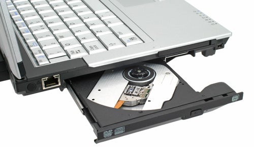 Close-up of a silver Samsung Q35 laptop with its DVD drive tray ejected, displaying the disc reading mechanism.