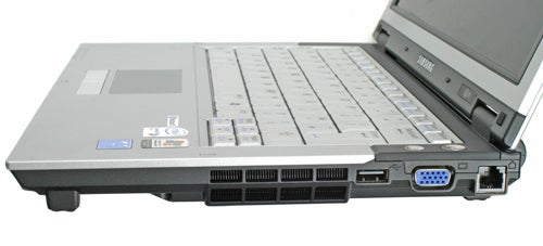 Side view of a Samsung Q35 Red laptop showing ports and the DVD drive with the screen partially opened and the keyboard visible.