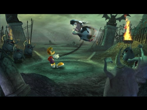 A screenshot from the video game Rayman Raving Rabbids showing Rayman being pulled by a rabbid attached to a chain, with other rabbids observing, set against a gloomy, desolate landscape.