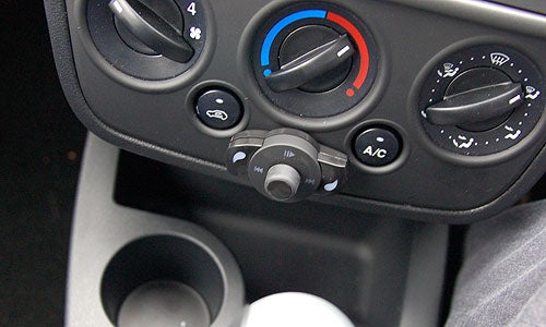 Parrot MK6000 Bluetooth car kit installed in a vehicle's central console near the air conditioning controls.