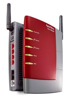 AVM Fritz!Box Fon WLAN 7140 router with two antennas and illuminated status indicators for power, DSL, internet, fixed-line network, and WLAN.