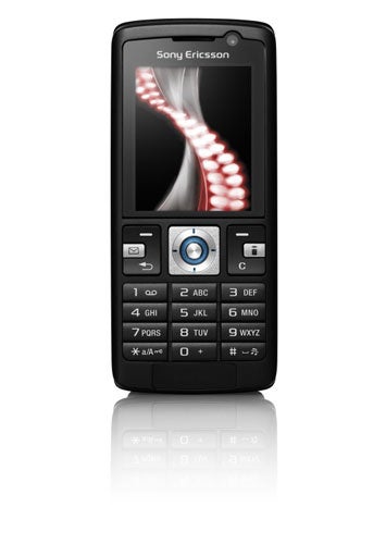 Sony Ericsson K610im mobile phone on a white background, featuring a color screen displaying an abstract red swirl design, a navigation joystick, numeric keypad, and dedicated buttons for camera and i-mode services.
