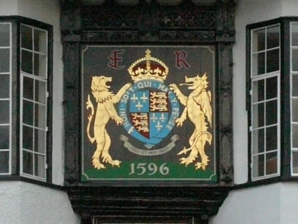 The image you've provided does not relate to the Panasonic DMC-L1 Digital SLR or any product review. The image is of a colorful heraldic crest featuring two golden lions, a shield with a blue and red design, a crown at the top, and the date 1596 displayed at the bottom. This crest is mounted on the exterior of a building with half-timbered architectural details.