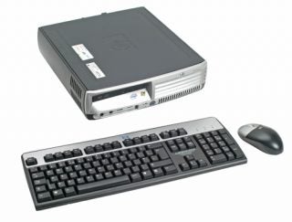 HP Compaq dc7700p Ultra-slim Desktop computer with keyboard and mouse on a white background.