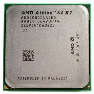 AMD Athlon 64 X2 5000+ EE CPU with its model and serial numbers on a gray background, highlighting the text and logo, assembled in Malaysia, circa 2005.