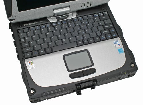 Panasonic ToughBook CF-19 rugged laptop partially open with visible keyboard and touchpad, Intel and Windows stickers, and a swivel screen hinge.