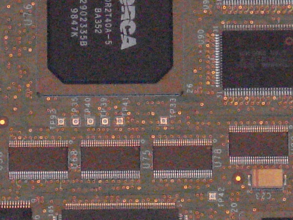 Close-up of a circuit board with integrated circuits and electronic components, potentially from inside an electronic device like a digital camera.