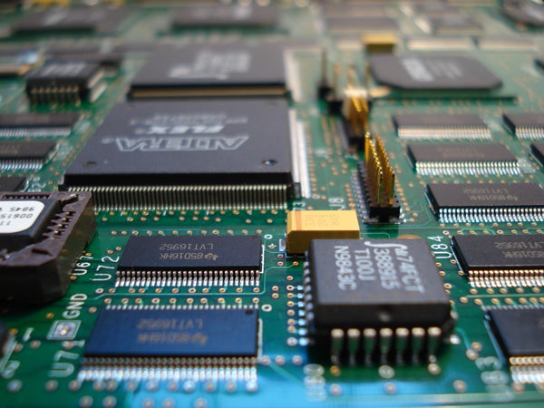 Close-up of a circuit board featuring multiple integrated circuits and electronic components.