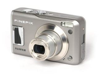 Fujifilm FinePix F31fd compact digital camera with a silver body, extended lens, and flash on a white background.