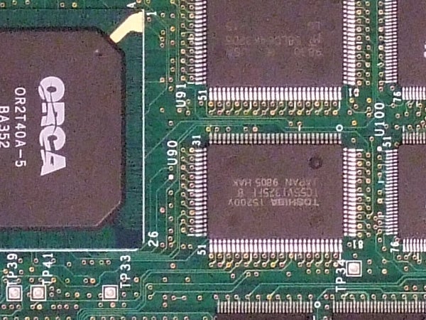 Close-up of electronic circuit board with integrated circuits and components, possibly from inside a digital camera such as the Fujifilm FinePix F31fd.