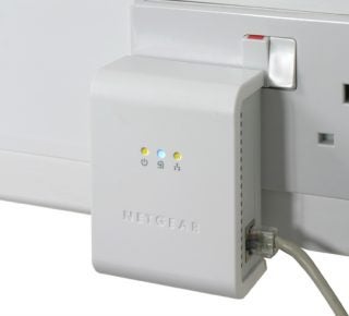 Netgear Powerline HD Ethernet Adapter connected to a wall outlet.