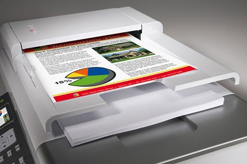 Lexmark X9350 printer with a color printout showing text and a pie chart on the output tray.
