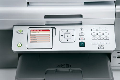 Close-up of the Lexmark X9350 multifunction printer's control panel with Wi-Fi connectivity indicator and color LCD screen displaying menu options.