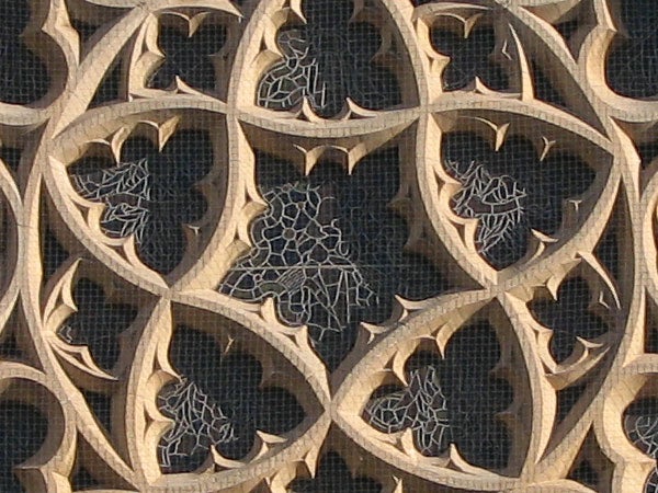 Intricate stone lattice window design showing geometric patterns and leaf motifs, demonstrating the detailed zoom capabilities of the Canon PowerShot S3 IS camera.
