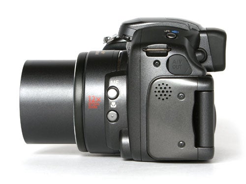 Canon PowerShot S3 IS digital camera with the lens extended, showing the left side with various control buttons and ports.