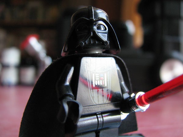 Close-up photo of a Lego Darth Vader figurine with a red lightsaber, demonstrating the depth of field capability of the Canon PowerShot S3 IS camera.