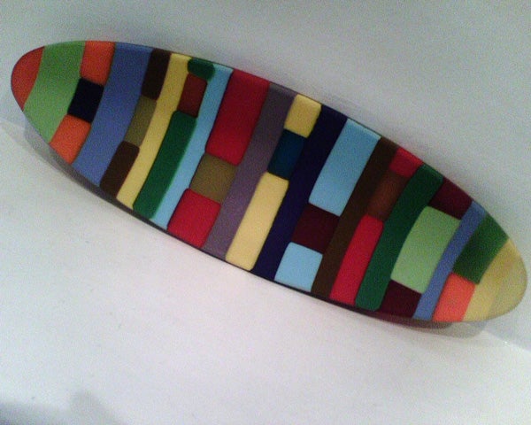 Colorful abstract pattern skateboard deck on a white background.