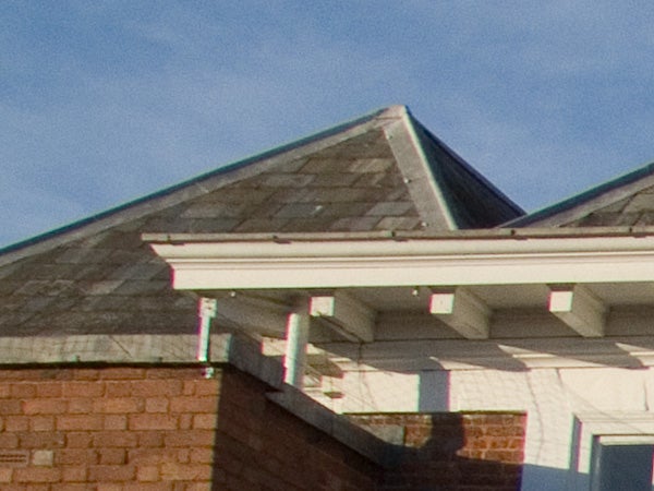 Close-up photo demonstrating the zoom capability of the Fujifilm FinePix S9600, showcasing architectural details of a building's roofline.