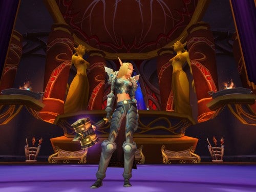 Screenshot from World of Warcraft: The Burning Crusade showing a female night elf character in a grand hall with purple and gold accents.