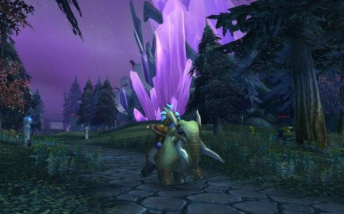 Screenshot from World of Warcraft: The Burning Crusade showing a character riding a beast with large purple crystals in the background within a dark forested landscape.