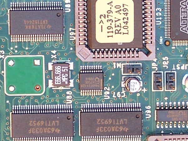 Close-up view of a camera's electronic circuit board displaying various integrated circuits, capacitors, and connections.